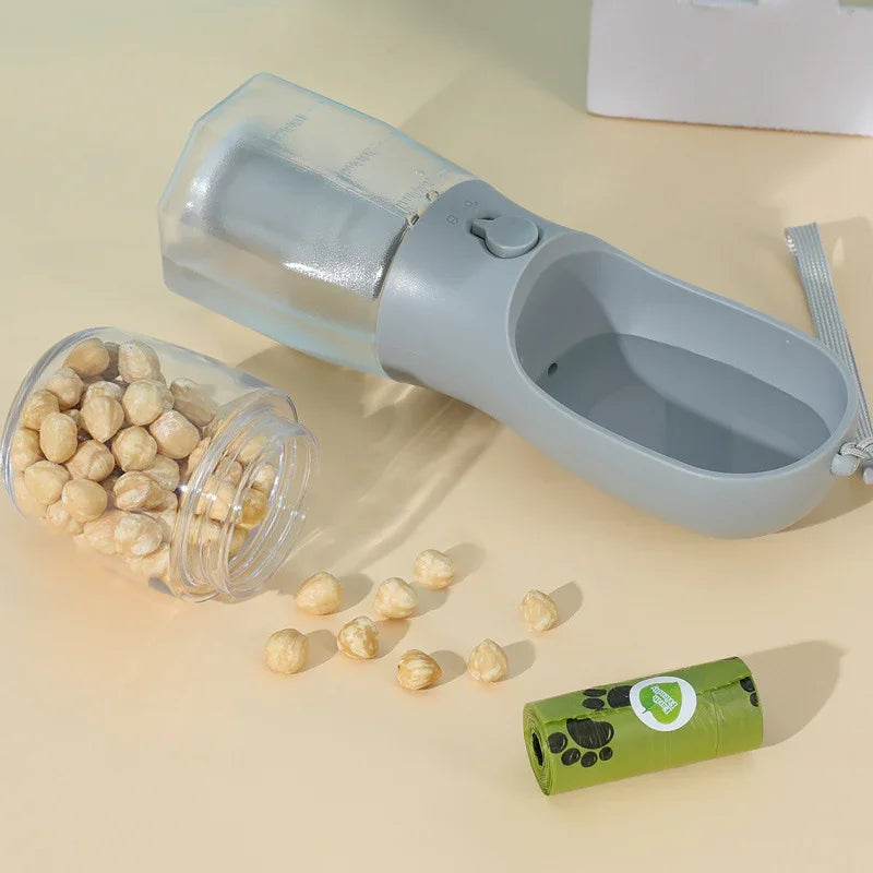 Portable pet water bottle with hazelnuts and eco-friendly waste bags nearby